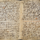 The beginning of Sūrah 12 (Sūrat Yūsuf, ‘Joseph’) showing the verse markers and also the red headings and circles which were added later.